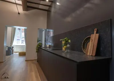 a kitchen with a black counter top in a room at Charme apartment with Spa in Piazza del Popolo in Rome