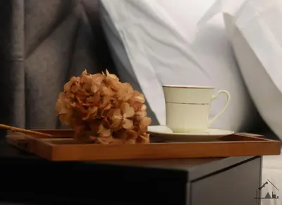 a tray with a coffee cup and a flower on it at Charme apartment with Spa in Piazza del Popolo in Rome