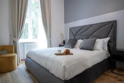 a bedroom with a large bed with a tray on it at Charme apartment with Spa in Piazza del Popolo in Rome