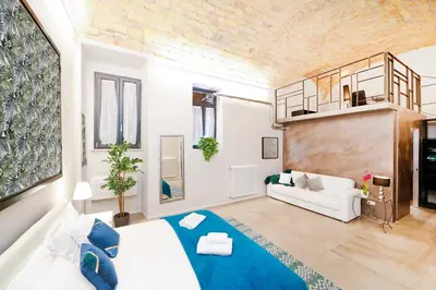 a living room with a bed and a couch at Post Industrial Loft Trastevere - Top Collection in Rome