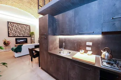 a kitchen with a sink and a counter top at Post Industrial Loft Trastevere - Top Collection in Rome