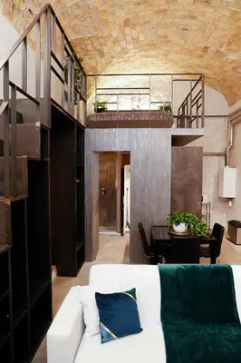 a living room with a white couch and a table at Post Industrial Loft Trastevere - Top Collection in Rome