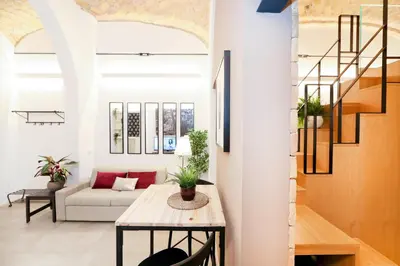 a living room with a table and a couch at Sky Dream Loft Trastevere in Rome