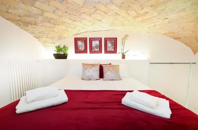 a bedroom with a large bed with a red blanket at Sky Dream Loft Trastevere in Rome