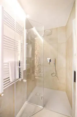 a shower with a glass door in a bathroom at Sky Dream Loft Trastevere in Rome