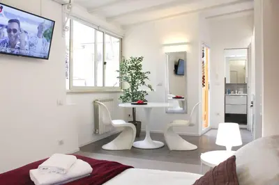 a bedroom with a bed and a table and chairs at Bright Cozy Studio Trastevere in Rome