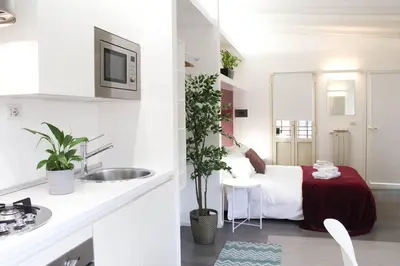 a bathroom with a bed and a sink in a room at Bright Cozy Studio Trastevere in Rome
