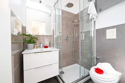 a bathroom with a shower and a toilet and a sink at Bright Cozy Studio Trastevere in Rome