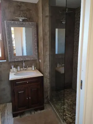 a bathroom with a shower and a sink and a mirror at SUPERATTICO SUL COLOSSEO in Rome