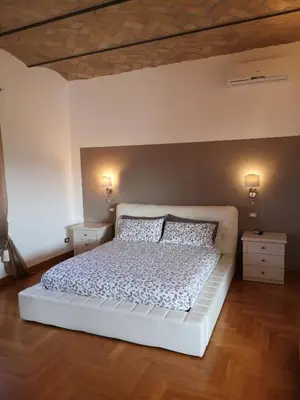 a bedroom with a white bed with two pillows at SUPERATTICO SUL COLOSSEO in Rome