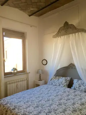 a bedroom with a bed and a window at SUPERATTICO SUL COLOSSEO in Rome