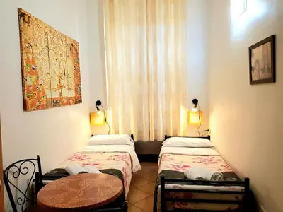 three beds in a room with red walls at Legend R.G. in Rome