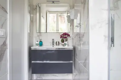 a bathroom with a blue sink and a mirror at Silver Luxury Jacuzzi Suite Trastevere in Rome