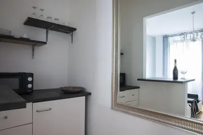 a mirror in a kitchen with a counter and a microwave at Silver Luxury Jacuzzi Suite Trastevere in Rome