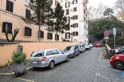 a row of cars parked on the side of a street at Pink Intimate Jacuzzi Suite Trastevere in Rome