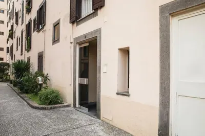 a white building with a door on the side of it at Pink Intimate Jacuzzi Suite Trastevere in Rome