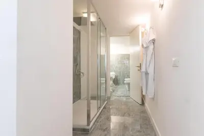 a bathroom with a walk in shower and a toilet at Campo dè Fiori Detached Apartment Eligio - Top Collection in Rome