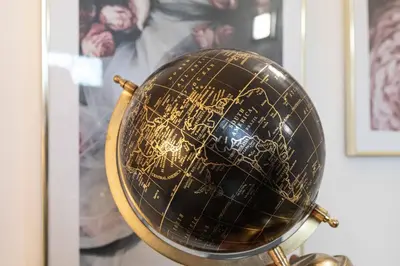 a golden globe on a stand in front of a picture at Campo dè Fiori Detached Apartment Eligio - Top Collection in Rome
