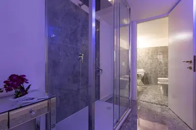 a bathroom with a glass shower and a toilet at Campo dè Fiori Detached Apartment Eligio - Top Collection in Rome