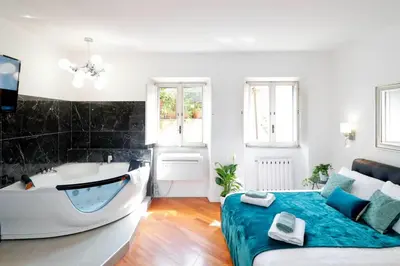 a living room with a bath tub and a bed at Pantheon Amazing Jacuzzi Suite in Rome