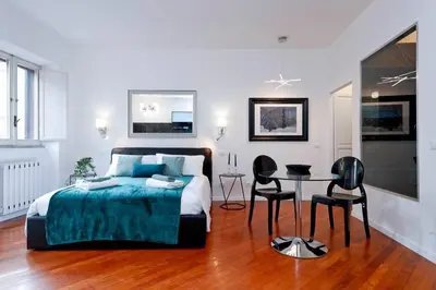 a bedroom with a bed and a table and chairs at Pantheon Amazing Jacuzzi Suite in Rome