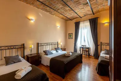 a hotel room with two beds and a window at Roma family apartment in Rome