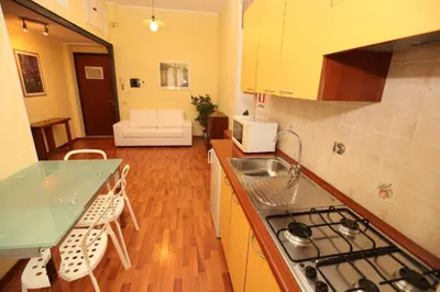 a kitchen with a sink and a stove top oven at Roma family apartment in Rome