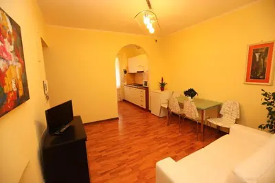 a living room with a couch and a table with a laptop at Roma family apartment in Rome