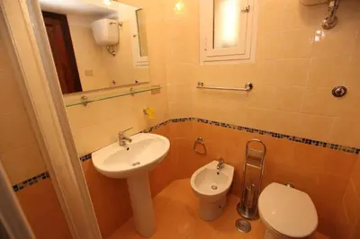 a bathroom with a sink and a toilet at Roma family apartment in Rome