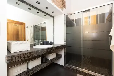 a bathroom with a sink and a mirror at Rufina Apartment in Rome