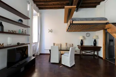 a living room with a table and a loft bed at Rufina Apartment in Rome