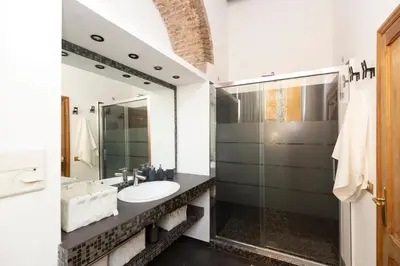 a bathroom with a sink and a mirror at Rufina Apartment in Rome