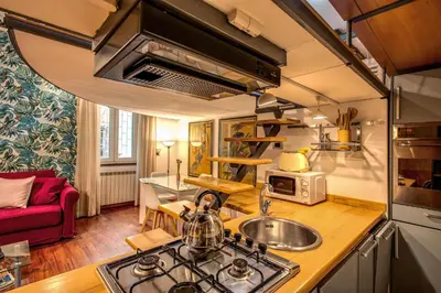 a kitchen with a sink and a stove top oven at San Calisto Suite in Rome