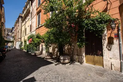 an alley with a tree on the side of a building at San Calisto Suite in Rome