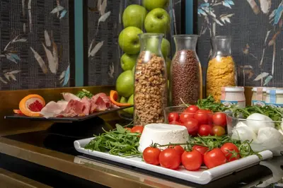 a counter topped with lots of different types of food at The Inn at the Spanish Steps Luxury Collection - Mario De' Fiori Suite in Rome