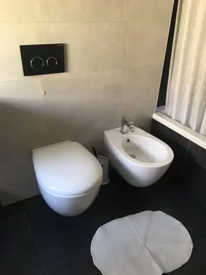 a bathroom with a white toilet and a sink at B&B Affaccio sul Vaticano in Rome