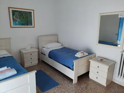 a bedroom with two beds and a mirror at Andreina a San Pietro Apartment in Rome