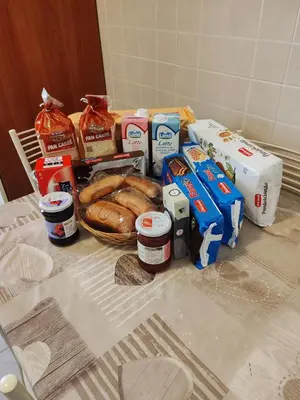 a table with bread and other food on it at Andreina a San Pietro Apartment in Rome