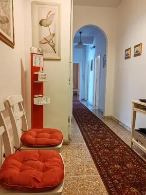 a hallway with two orange chairs in a room at Andreina a San Pietro Apartment in Rome