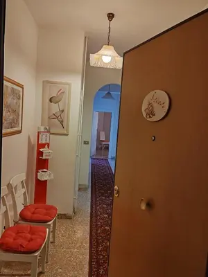 a room with two chairs and a door with a hallway at Andreina a San Pietro Apartment in Rome