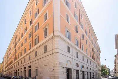 a large brick building on the side of a street at Cody's Apartment in Rome