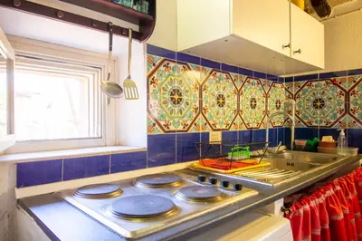 a kitchen with a stove top with a sink at Cody's Apartment in Rome