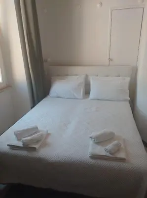 a bedroom with a bed with two towels on it at Cody's Apartment in Rome