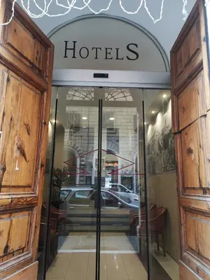 a store door with a hotel sign on it at Rome Travellers Hotel in Rome