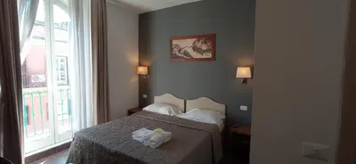 a bedroom with a bed with two towels on it at Rome Travellers Hotel in Rome