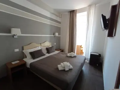 a bedroom with a bed with two towels on it at Rome Travellers Hotel in Rome