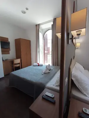 a hotel room with a bed and a window at Rome Travellers Hotel in Rome