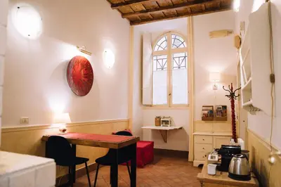 a small room with a table and a window at Limani - Navona Private Apartment in Rome