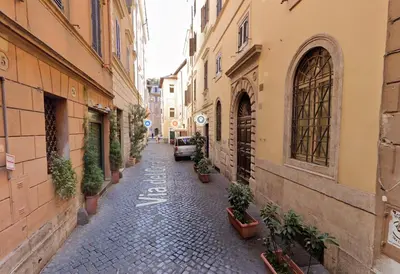 an alley with potted plants on the sides of buildings at Limani - Navona Private Apartment in Rome