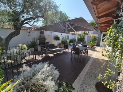 a patio with a table and an umbrella at Lilli Home - Urban Garden in Rome